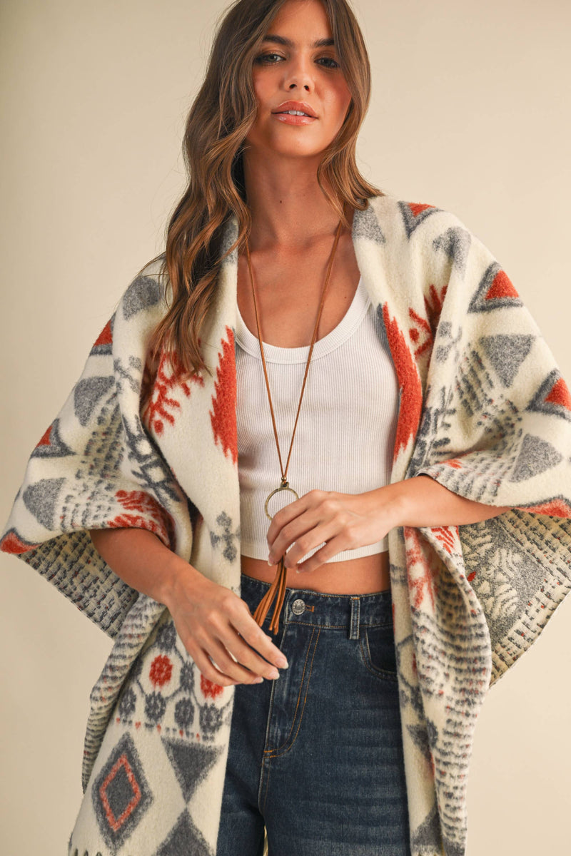 OVERSIZED FRINGED CAPE WITH PATTERNS