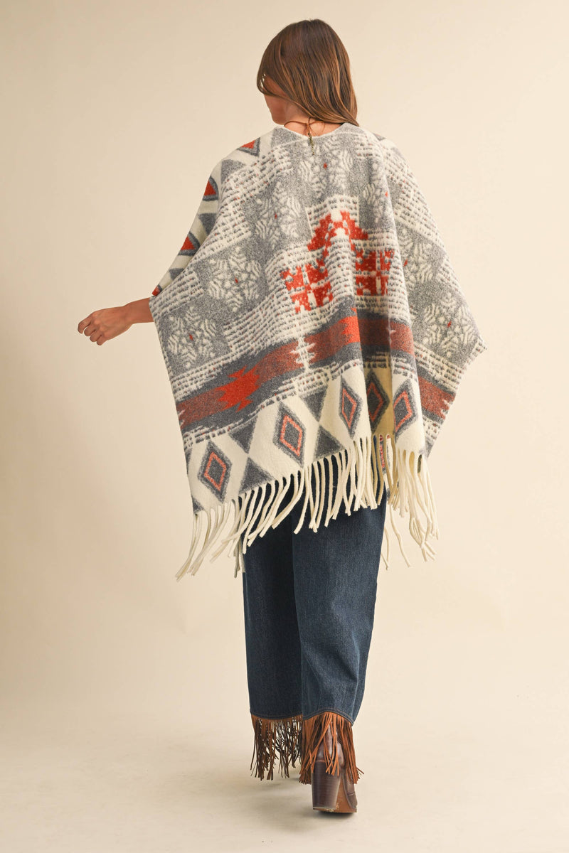 OVERSIZED FRINGED CAPE WITH PATTERNS
