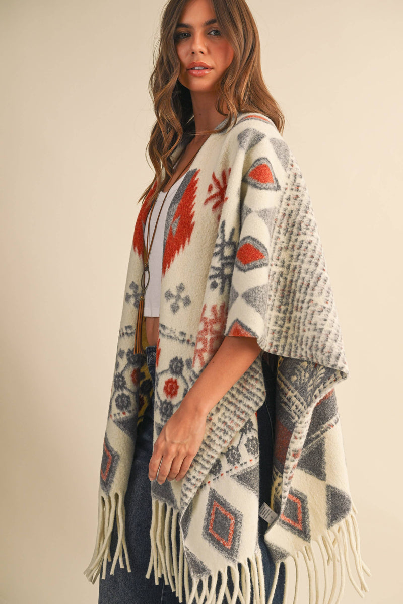 OVERSIZED FRINGED CAPE WITH PATTERNS