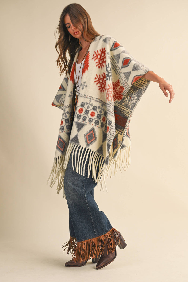 OVERSIZED FRINGED CAPE WITH PATTERNS
